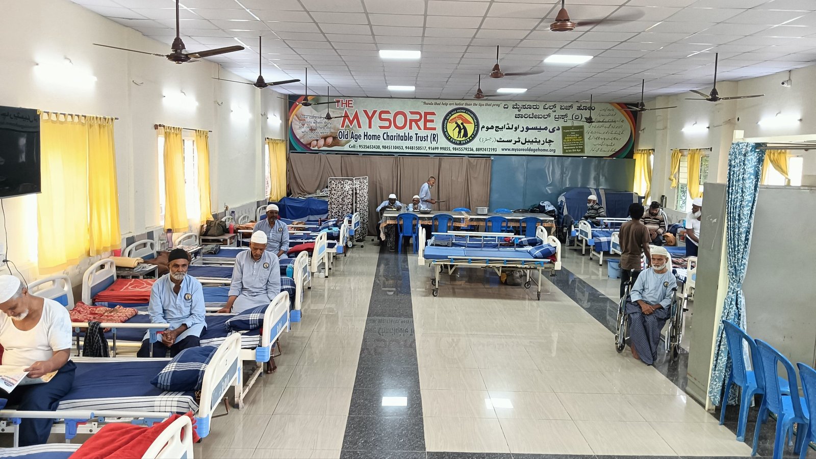 The main hall of the home, lined with beds where residents rest